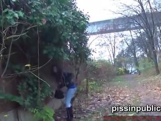 Daring girls pee on the frequented pathway and are seen by p