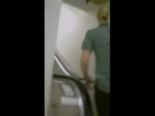 Captivating göt on an escalator in yoga pants